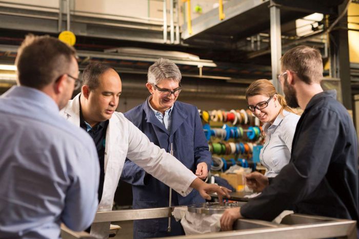CSIRO team members stand around the H membrame technology.